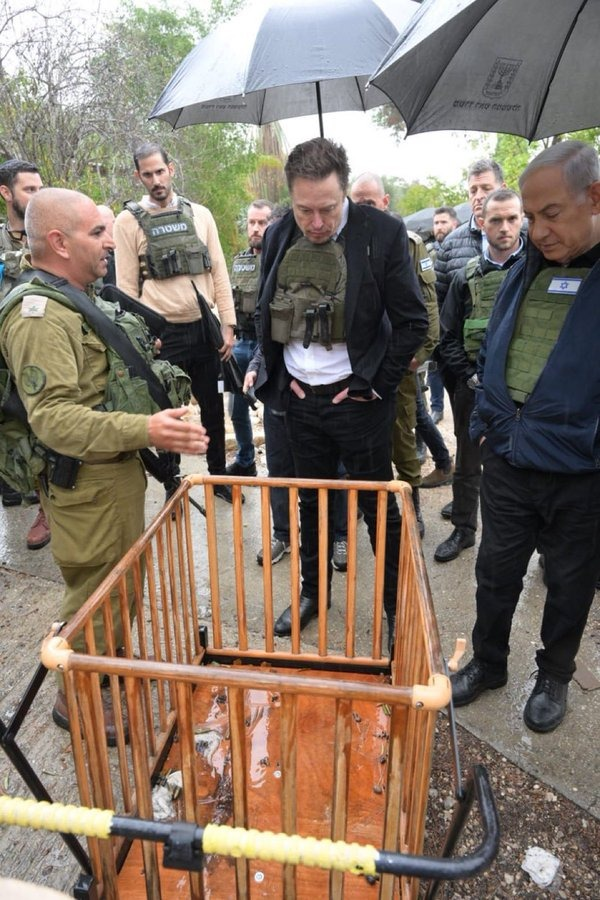Image in @MarioNawfal's post: 🚨 JUST IN: Elon Musk Dons Body Armor During Visit to October 7th Incident Site