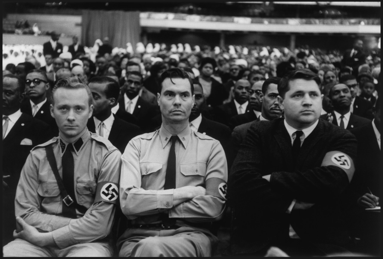 Image in @sneako's post: American Nazi Party members listening to Malcolm X speak at a black Muslim rally
(DC, 1961) https:/…